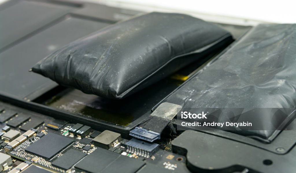 Lithium-ion battery on laptop, which has expanded.
