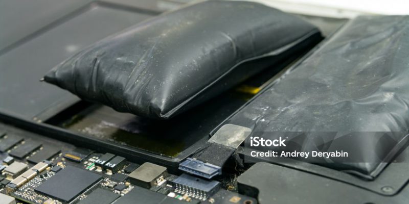Lithium-ion battery on laptop, which has expanded.